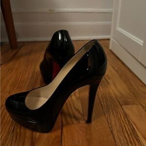 Louboutin black patent pumps like new. With red material bags.